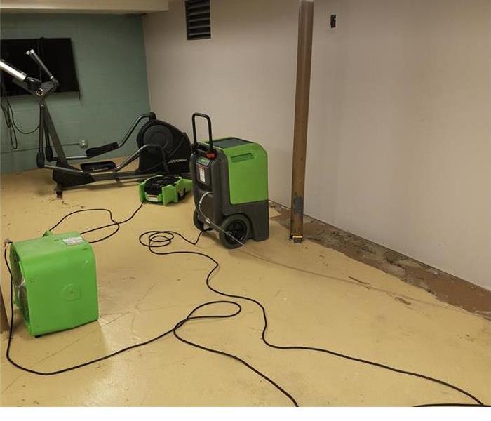 storage room with contents removed and drying equipment in place