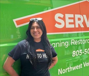 Admin Assistant standing in front of our business vehicle
