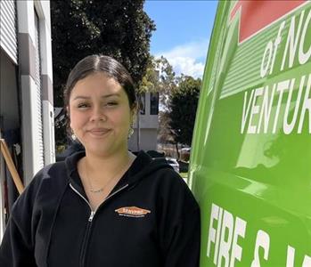 Office Manager of SERVPRO smiling in front of one of our business vehicles.