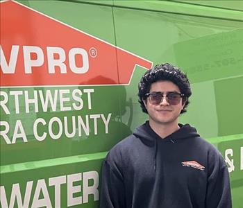 Crew Chief of SERVPRO smiling in front of one of our business vehicles.