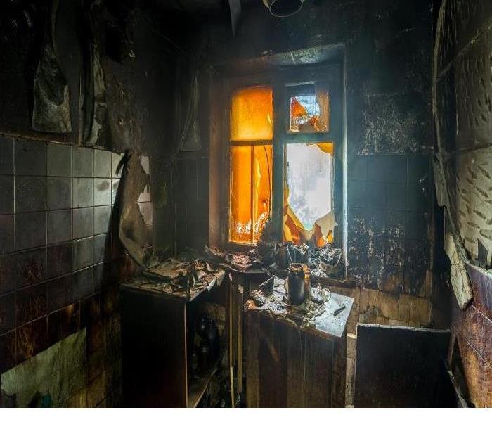 house fire damage showing burnt contents and missing broken window