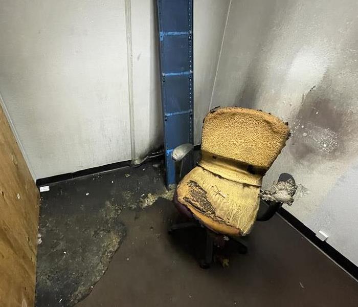 yellow office chair showing fire damage in office building
