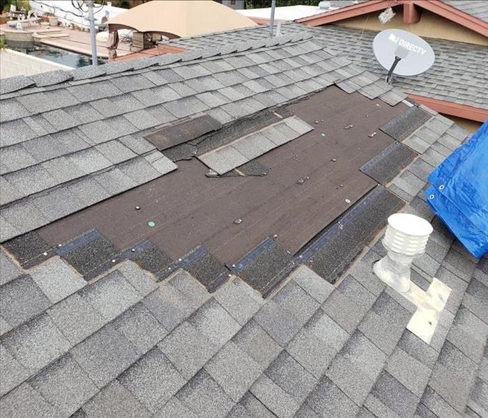 Missing shingles on a roof.